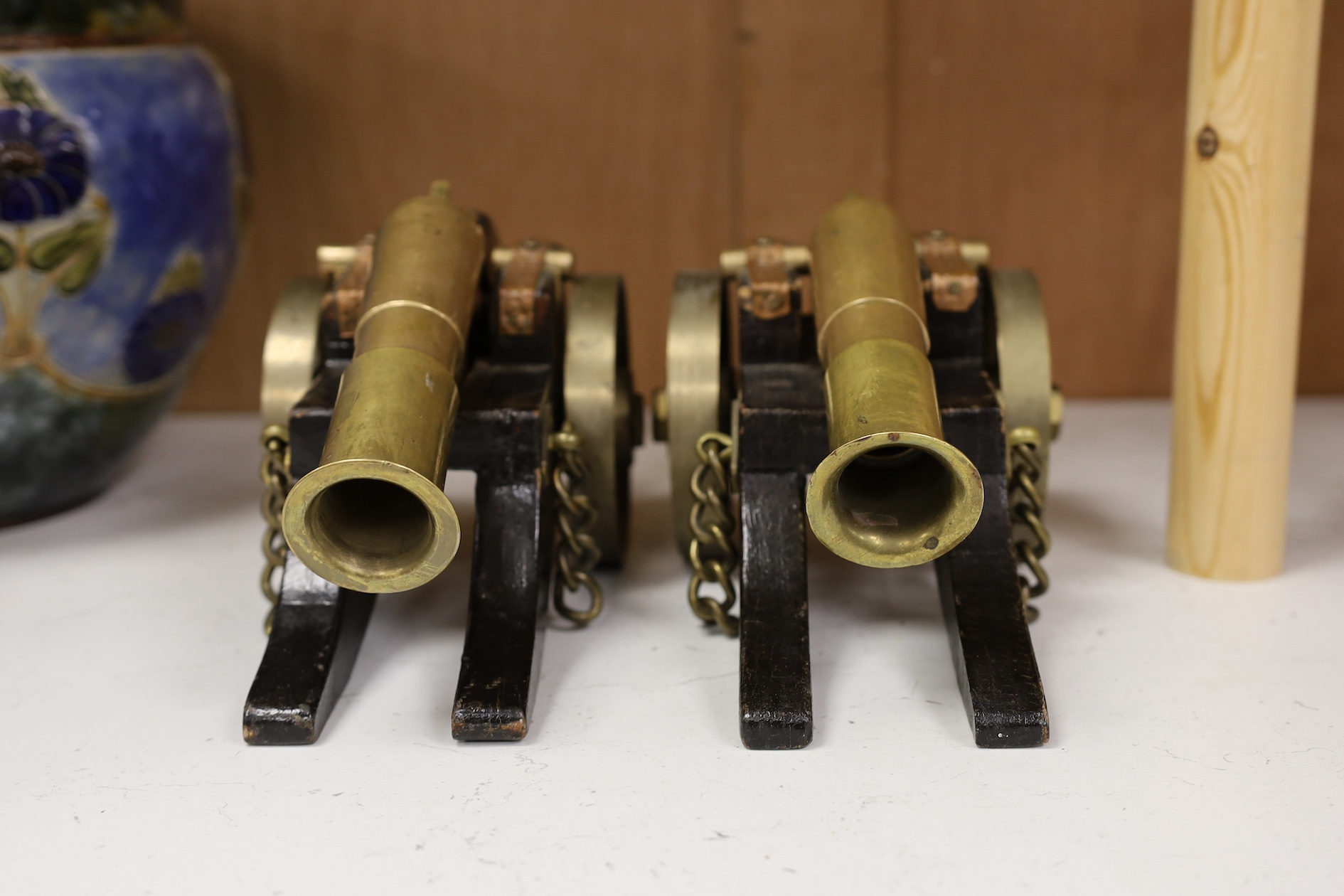 A pair of model bronze and wooden cannons, 27cm long. Condition - worn, strapping rusty